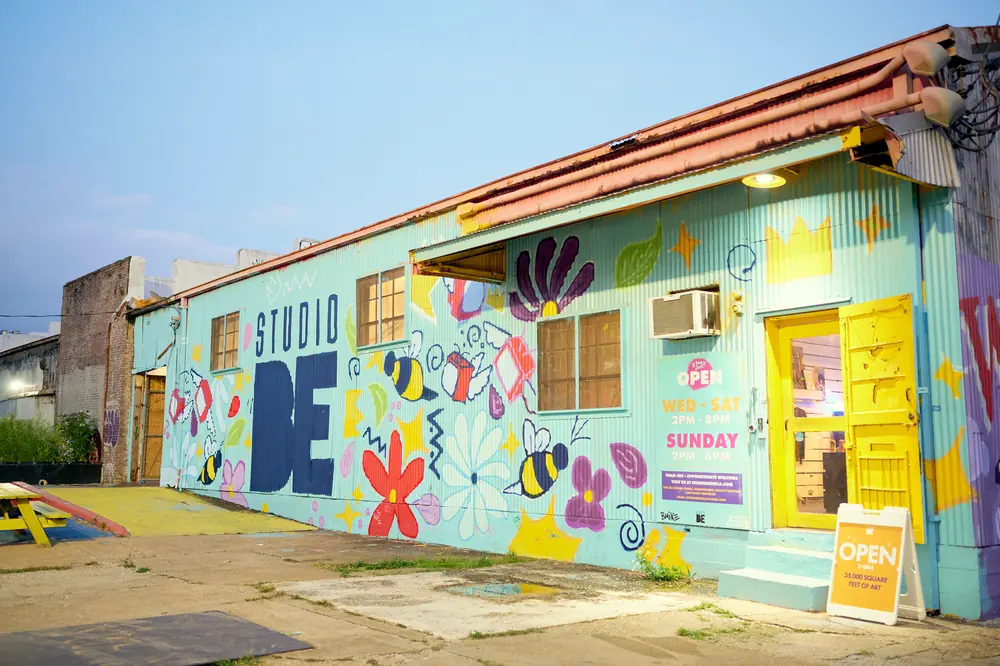The Studio BE warehouse, its exterior covered in colorful murals.