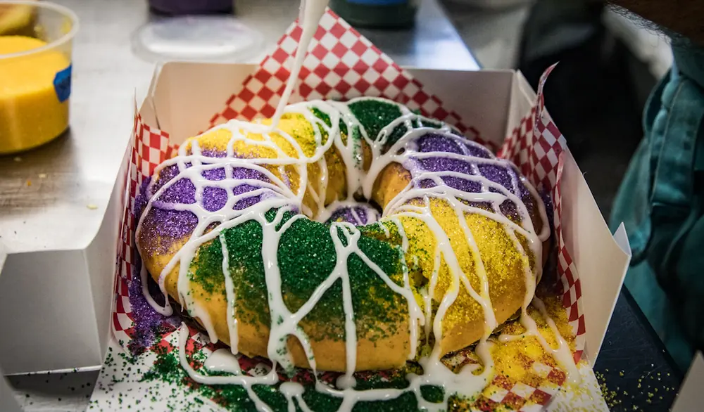A king cake in a paper-lined box.