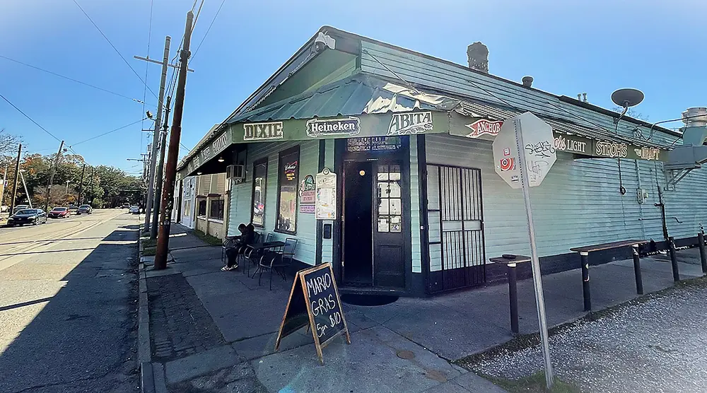 Carrollton Station, a low corner building with a green roof and beer signs on Willow Street.